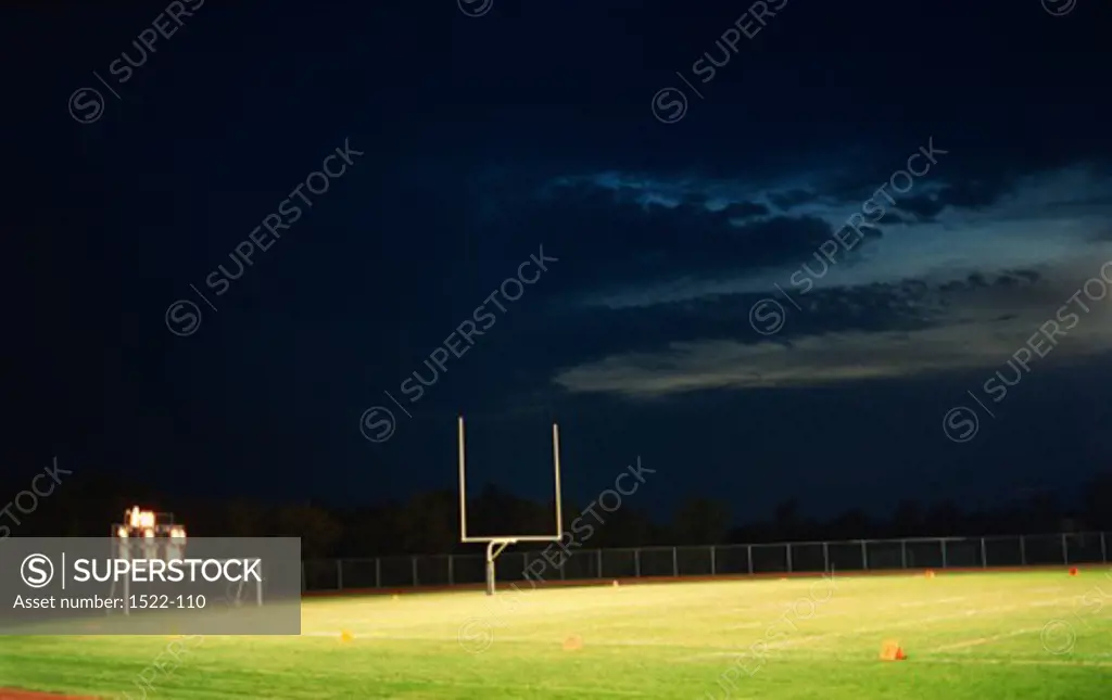 Goal post in an empty football field at night, Missouri, USA