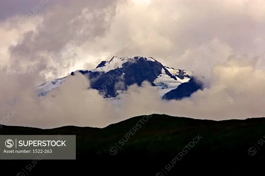 Snowcapped mountain surrounded by clouds, Alaska, USA