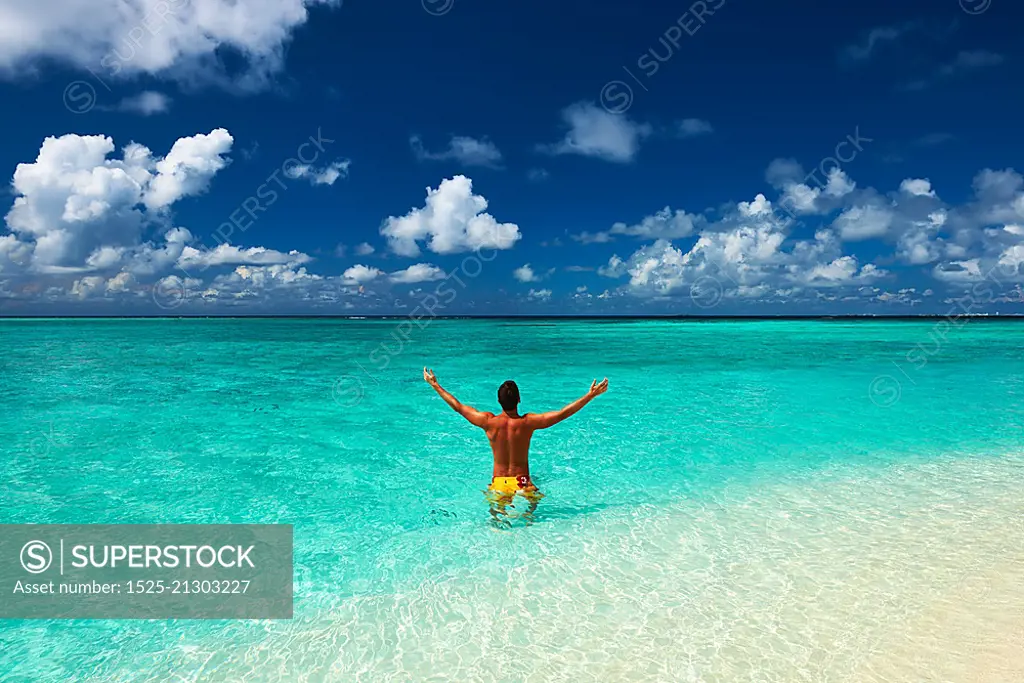 Man at tropical beach at Maldives