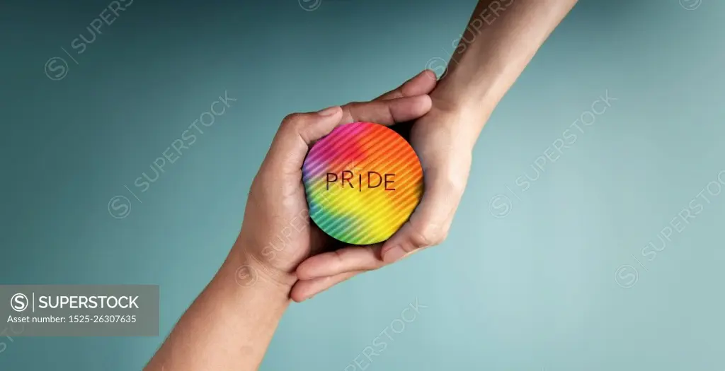 LGBTQ Concepts. Hands of Couple Embracing a Pride Rainbow Circle Together. Valentines Day. Pride month. Sign of Gender, Human Rights and Protest