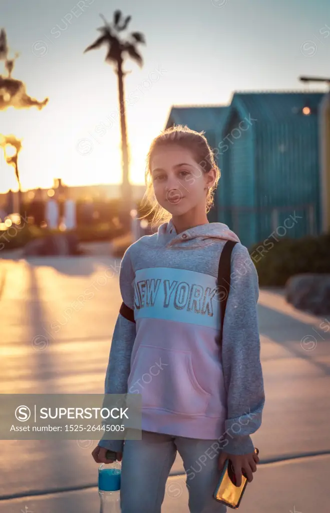 Portrait of a cute teen girl outdoors, happy active life of modern kids, genuine beauty of young girl, urban lifestyle