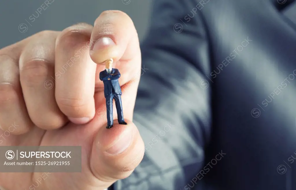 Big hand holding small businessman