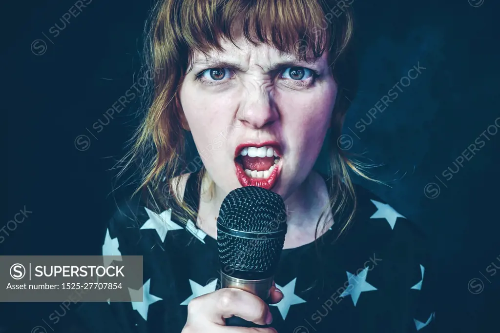Young woman singing a song with a microphone                               