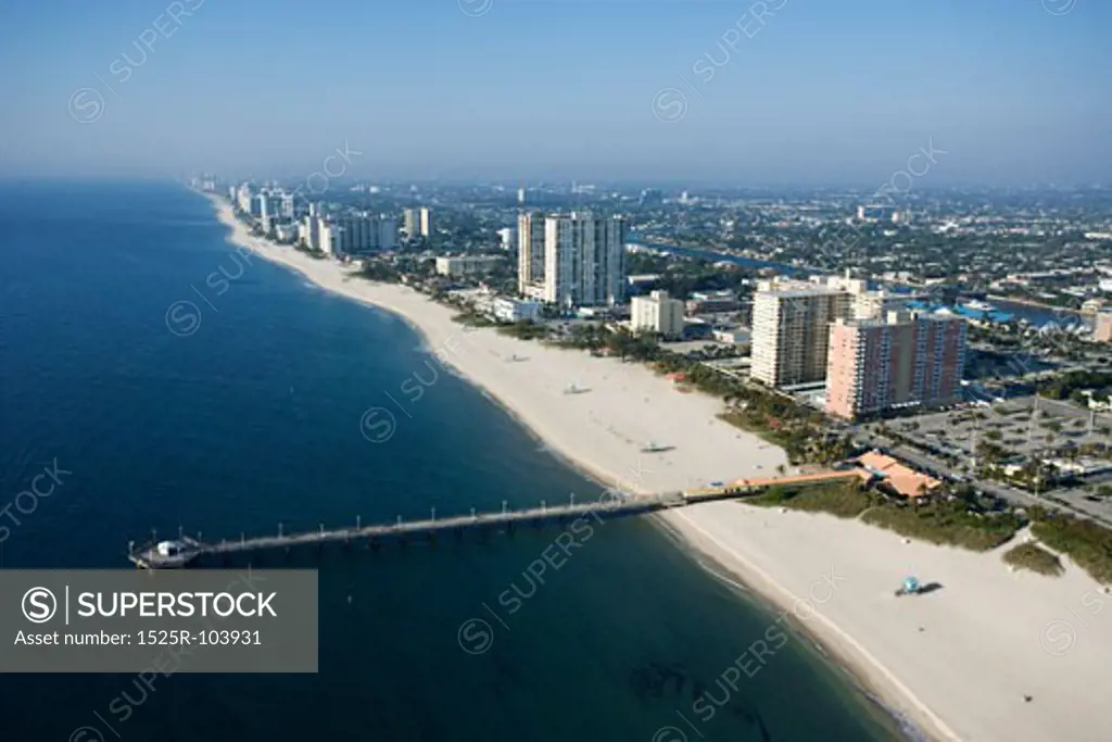 Aerial view of waterfront buildings and pier over ocean at Pompano Beach, Flordia.