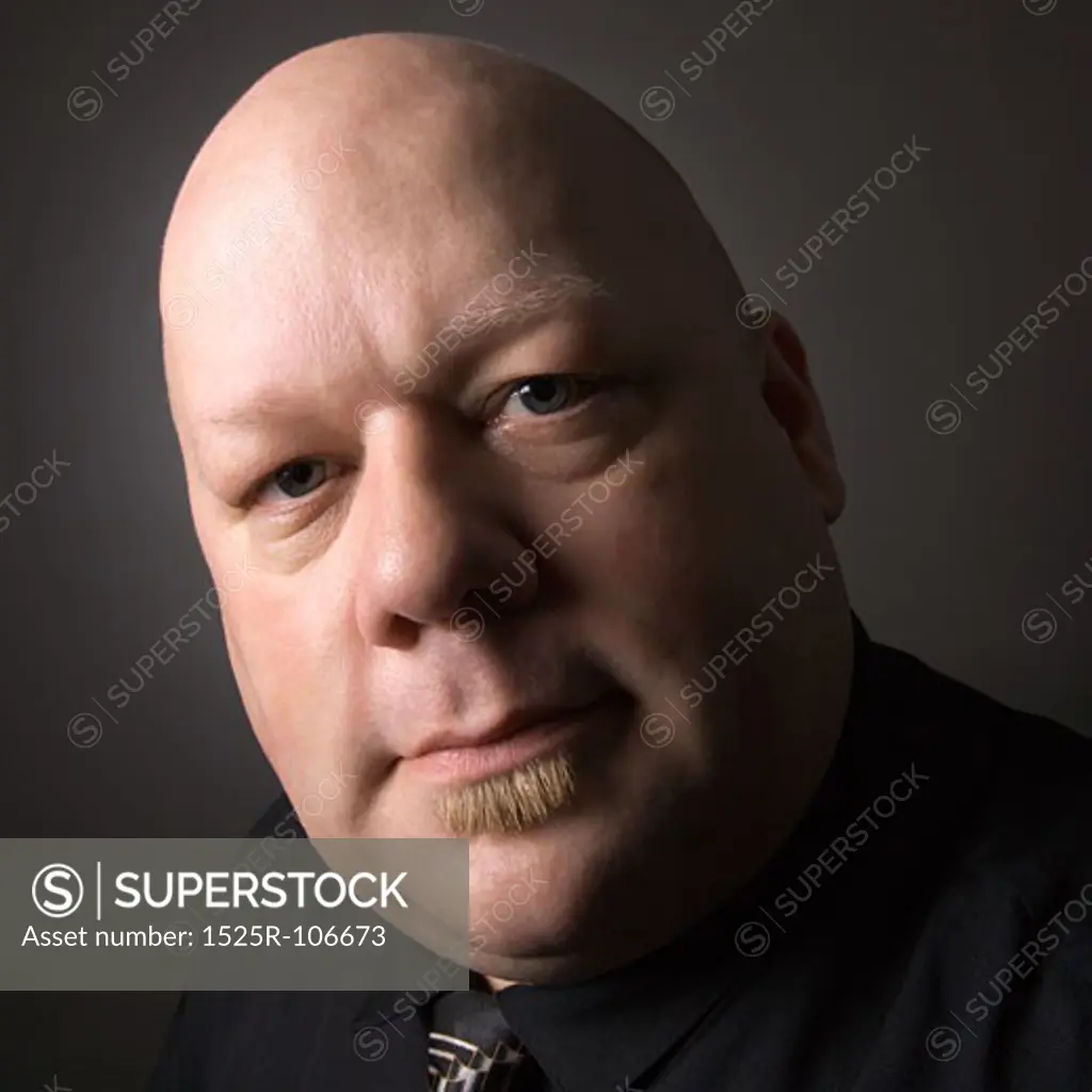 Caucasian mid adult bald man looking at viewer.