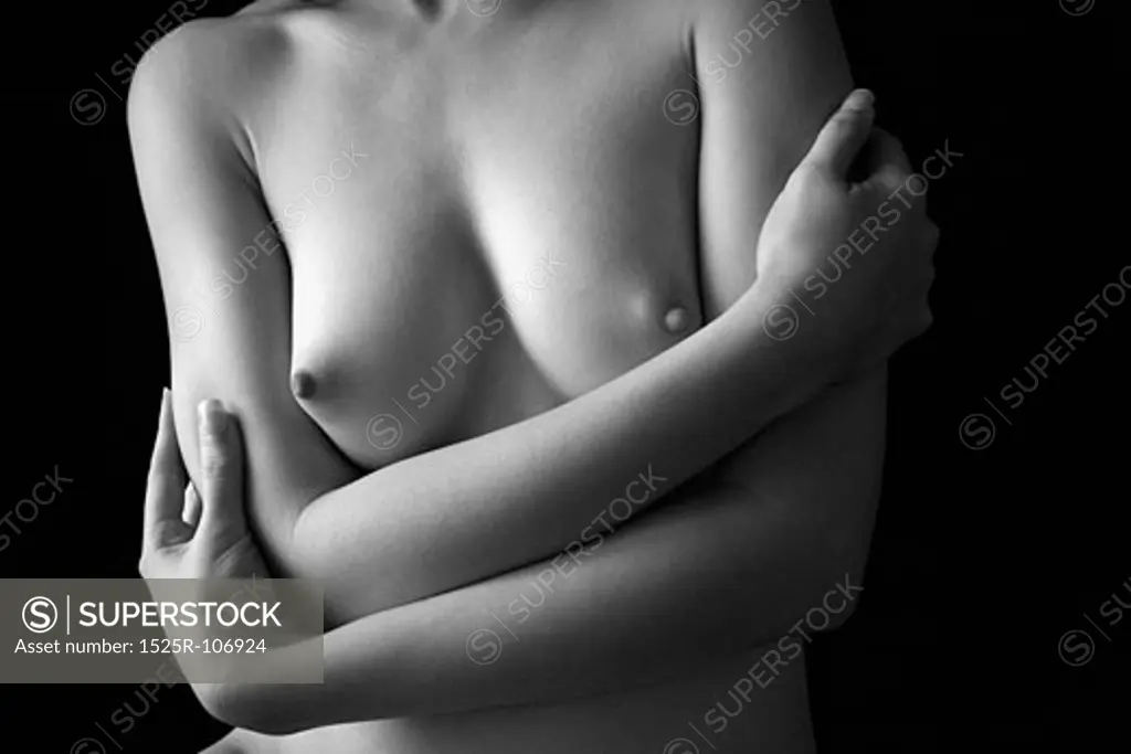 Nude young adult Caucasian female chest and arms.