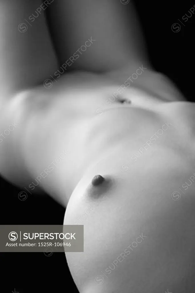 Nude young adult Caucasian female body lying down.