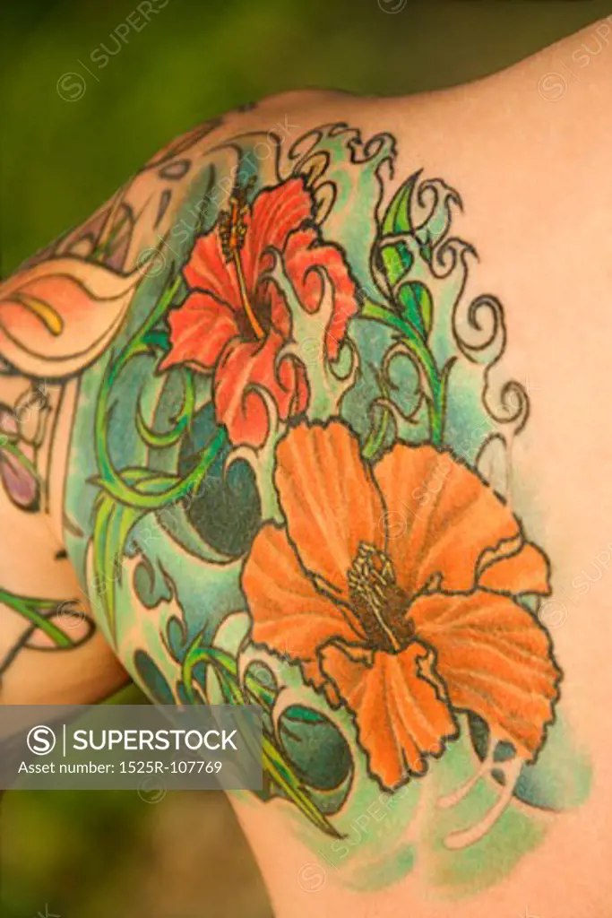 Close up of floral tattoo on shoulder of Caucasian woman.