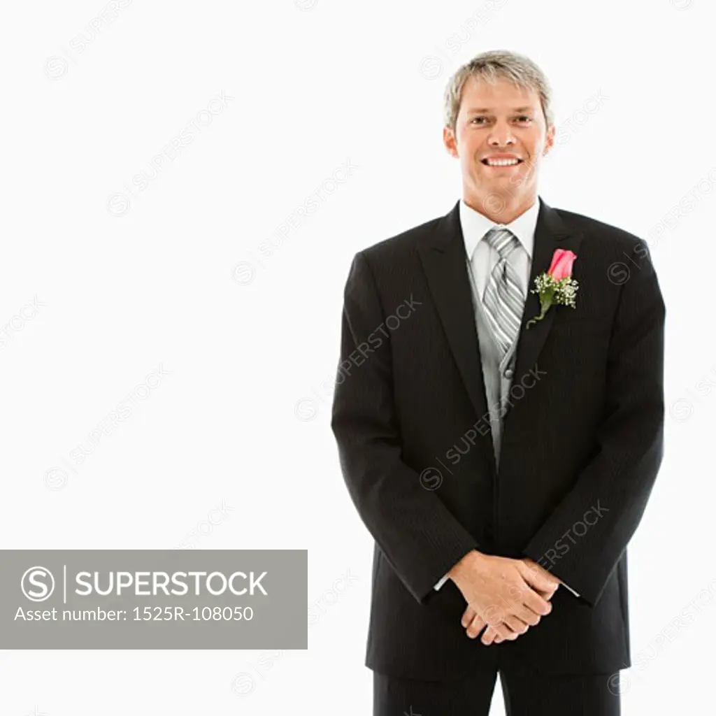 Portrait of Caucasian male in tuxedo with boutonniere.