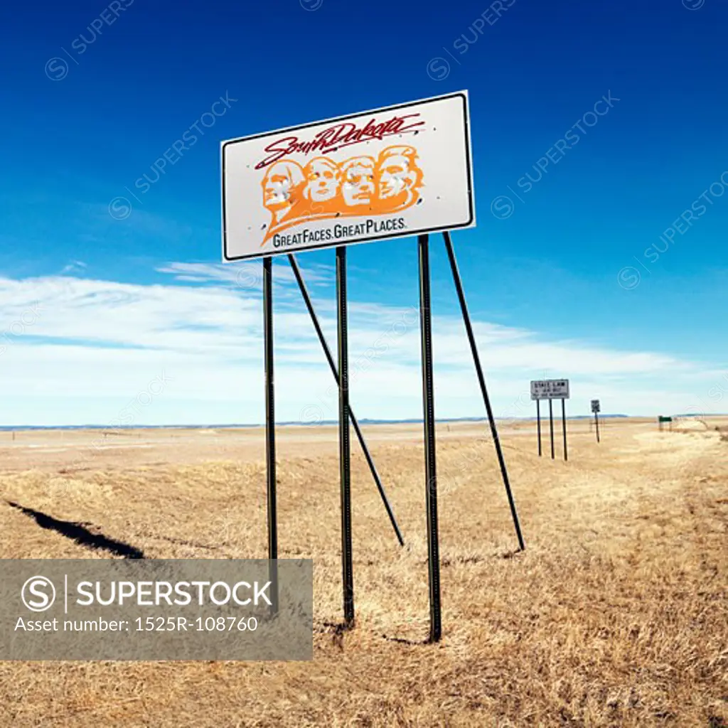 Sign with South Dakota's slogan on side of highway.