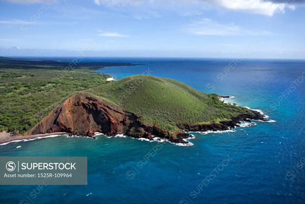 Aerial of Maui, Hawaii coastline with crater and cliffs on Pacific ocean.