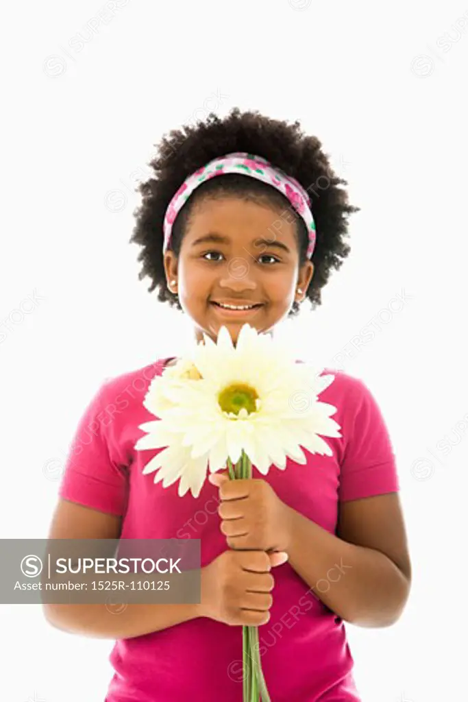 African American girl holding large Gerbera Daisies smiling at viewer.