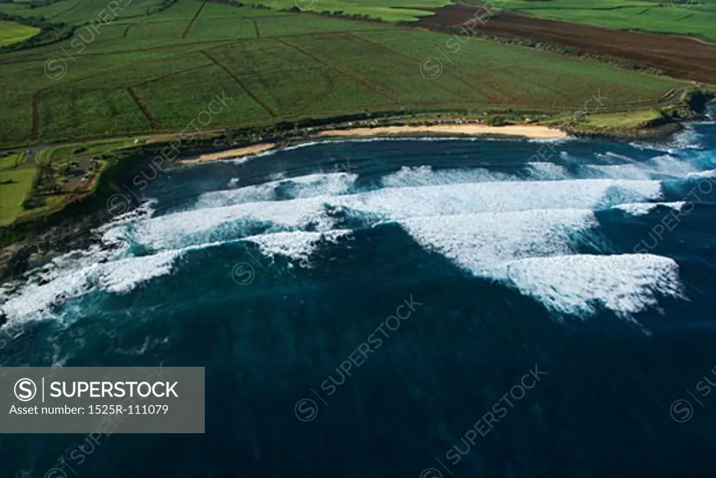 Aerial view of surf spot on coast of Maui, Hawaii with waves.