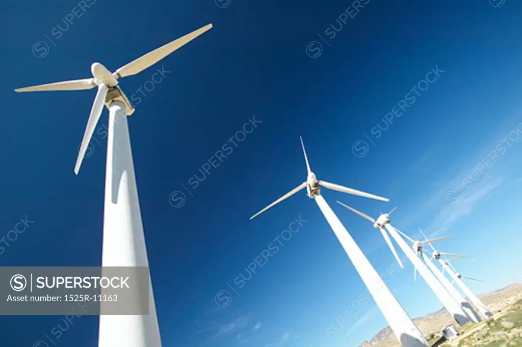 Low angle view of wind turbines on a farm