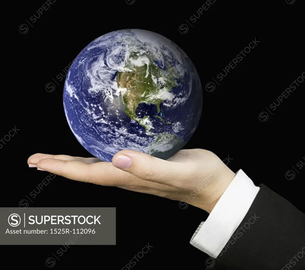 business hand holding globe over a black background