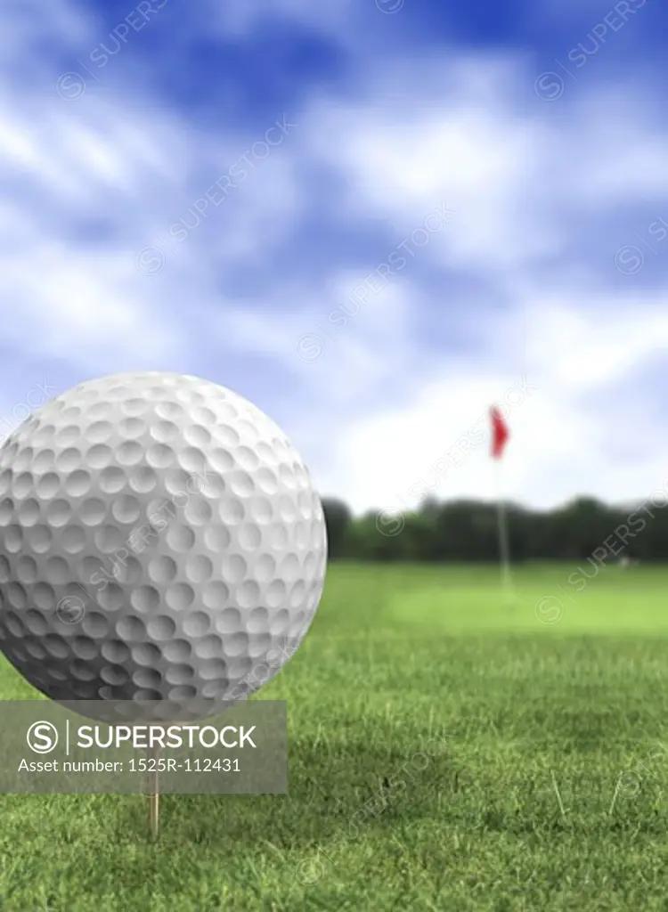 golf ball close up in a course with green grass and a blue sky