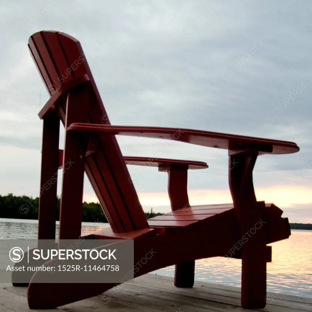 Adirondack chair on a pier at the lakeside, Lake of the Woods, Ontario, Canada