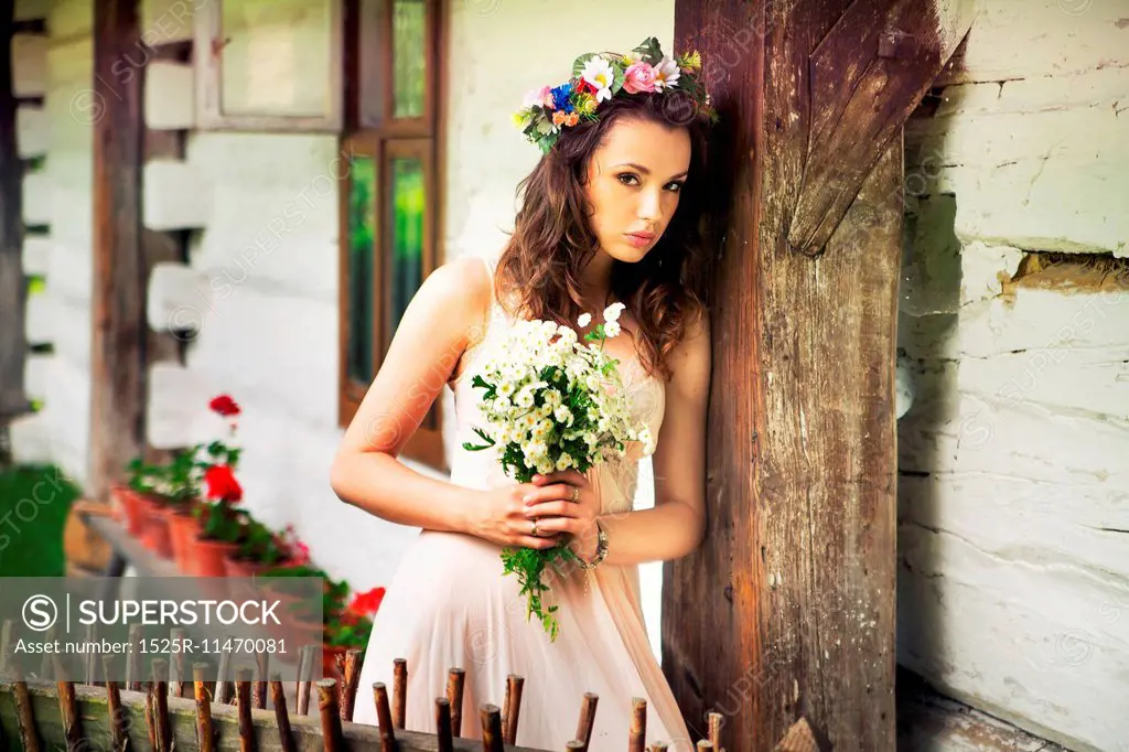 Young lady with buquet of wild flowers