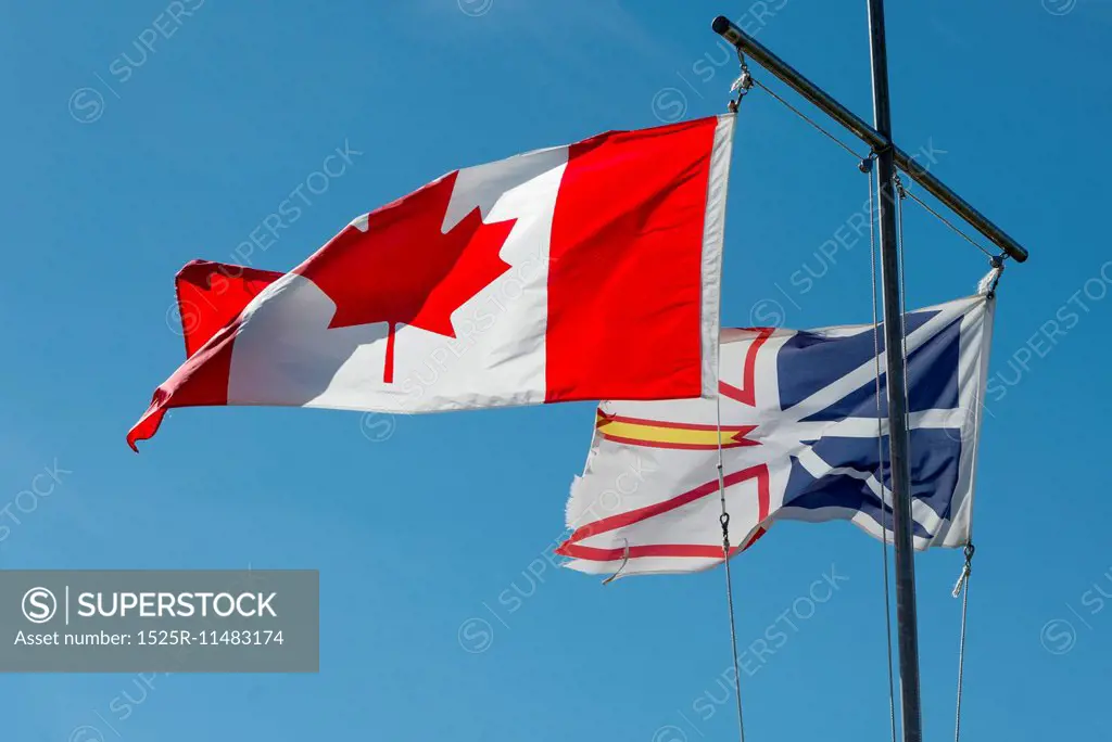 Low angle view of Canadian and Newfoundland flags, Twillingate, South Twillingate Island, Newfoundland And Labrador, Canada