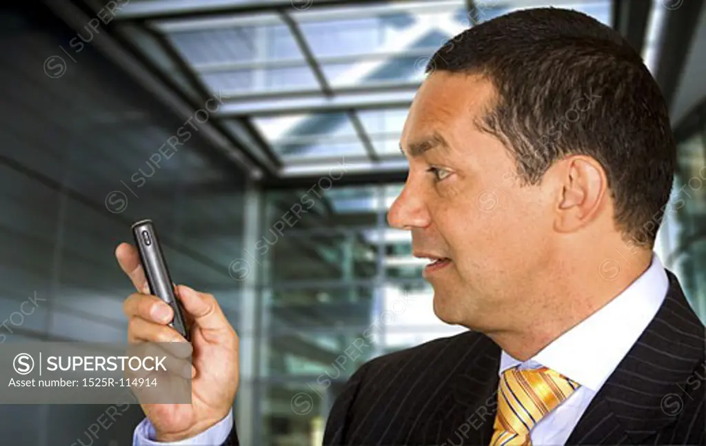 Business man with a mobile phone in a corporate environment