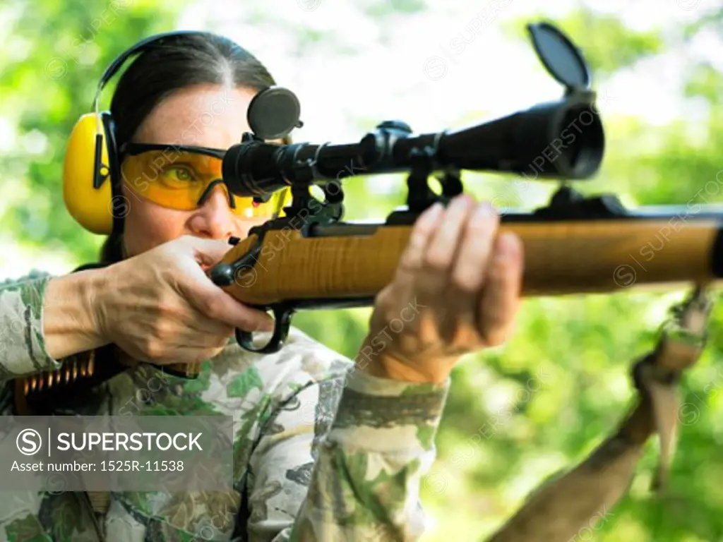 Caucasian Woman Firing A Rifle
