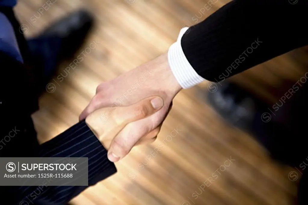 business handshake to seal the deal in an office