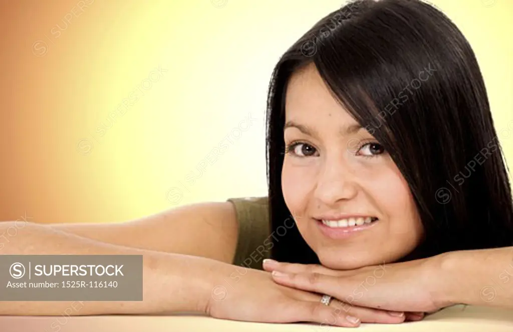 beautiful female portrait smiling over a golden background