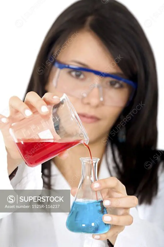 female chemist mixing liquids in test tubes