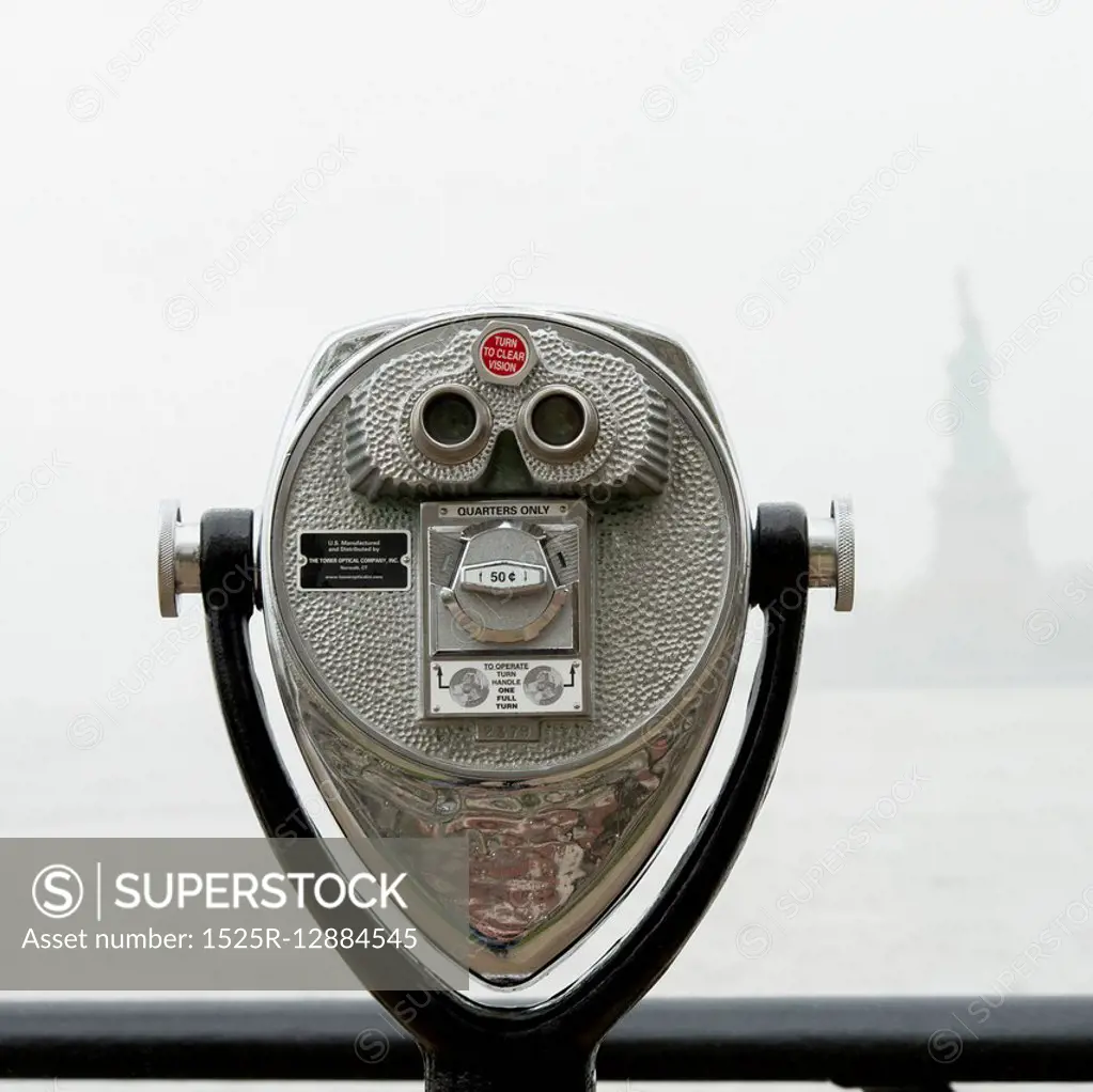 Binoculars looking towards the Statue of Liberty, Ellis Island, Jersey City, New York State, USA