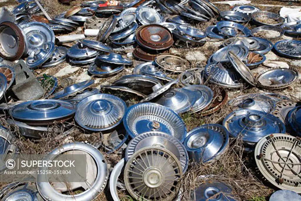 Old metal hubcaps strewn across the ground.