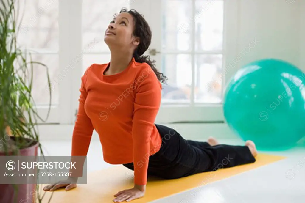 Attractive young African American woman in yoga Cobra pose