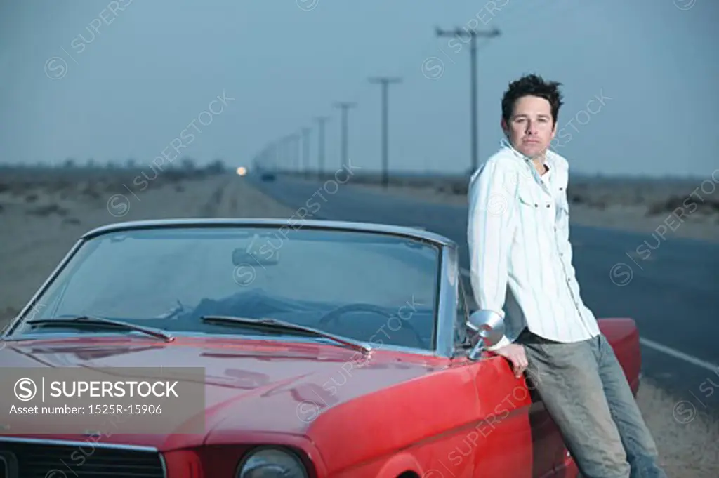 Adult standing next to car 