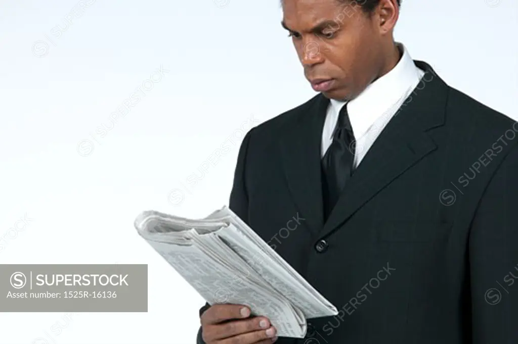 Businessman reading newspaper 