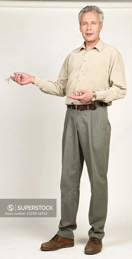 Man talking and gesturing with his eyeglasses