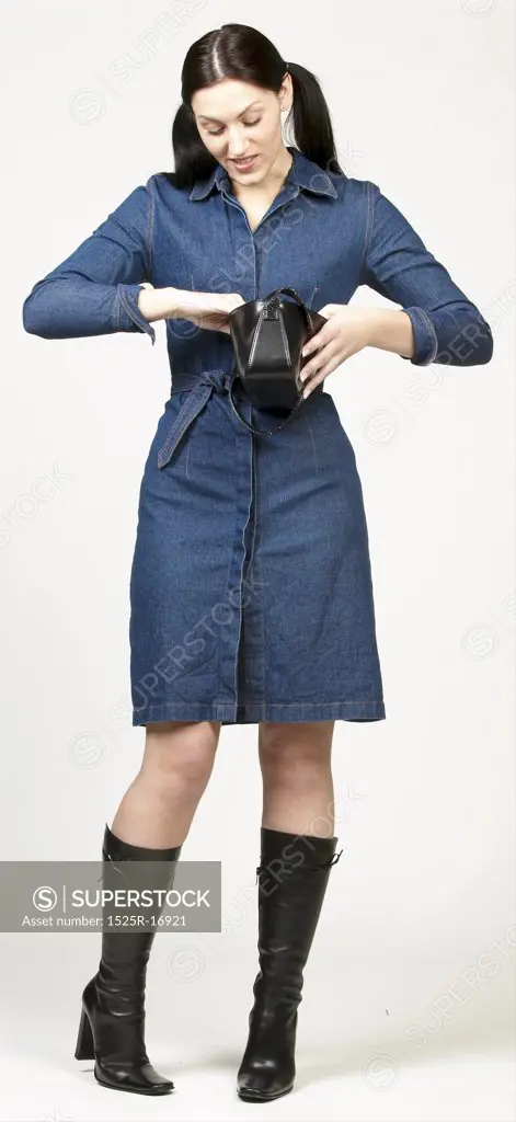 Woman in blue dress looking in her purse