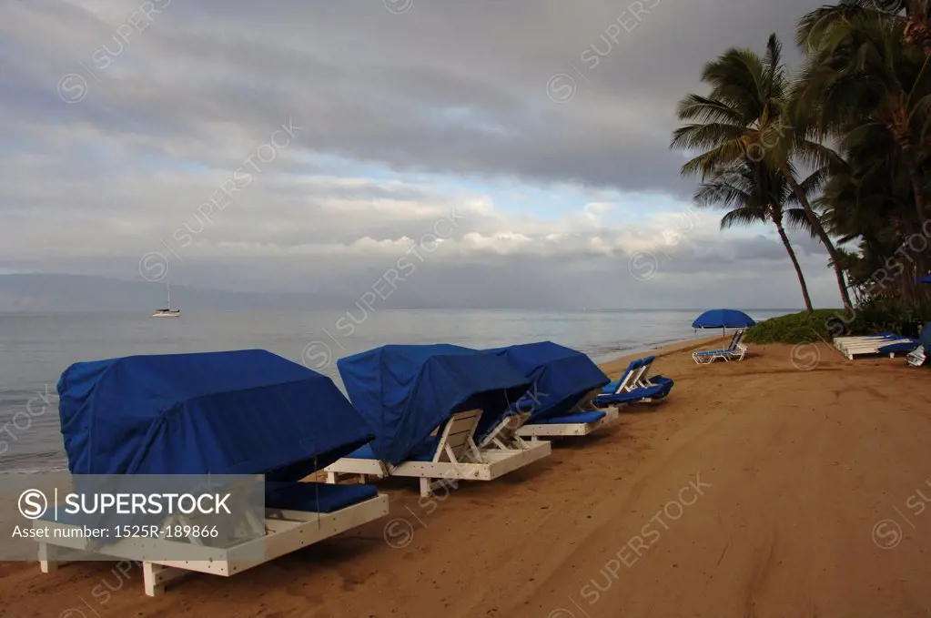 Covered lawn chairs at beach