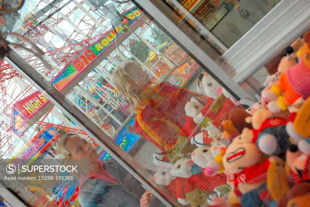 Girls playing arcade game at fairground