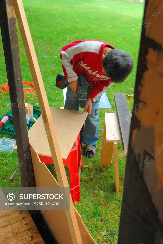 Young boy constructing woodwork