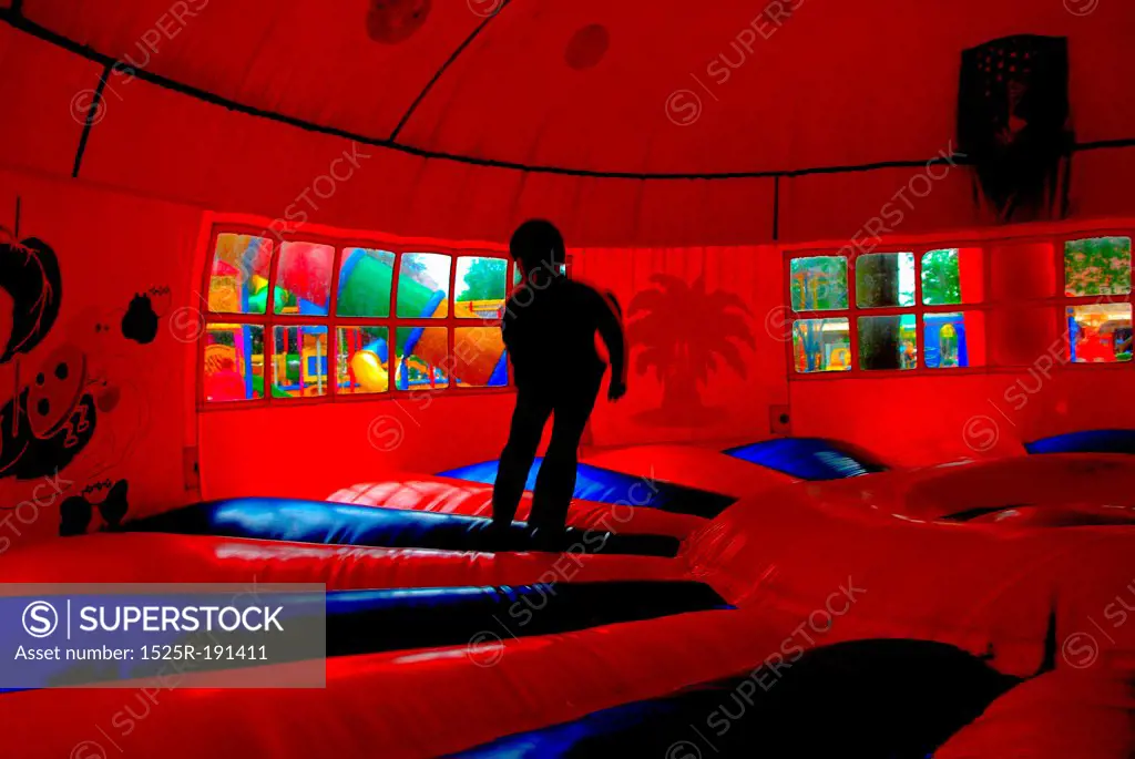 Boy jumping inside bouncy castle