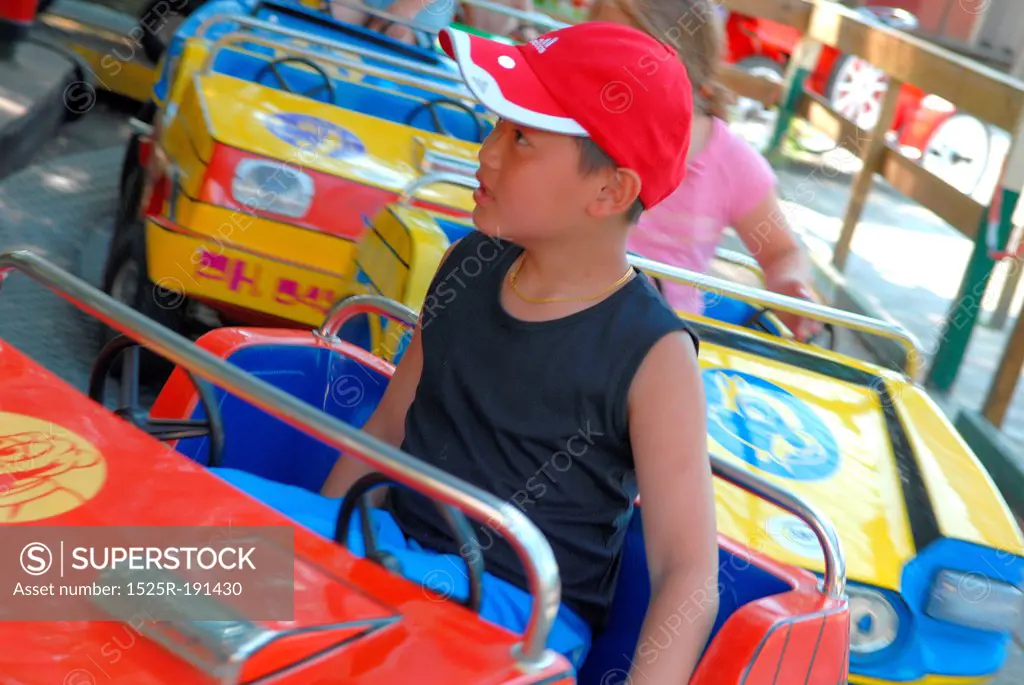 Young boy on fairground ride