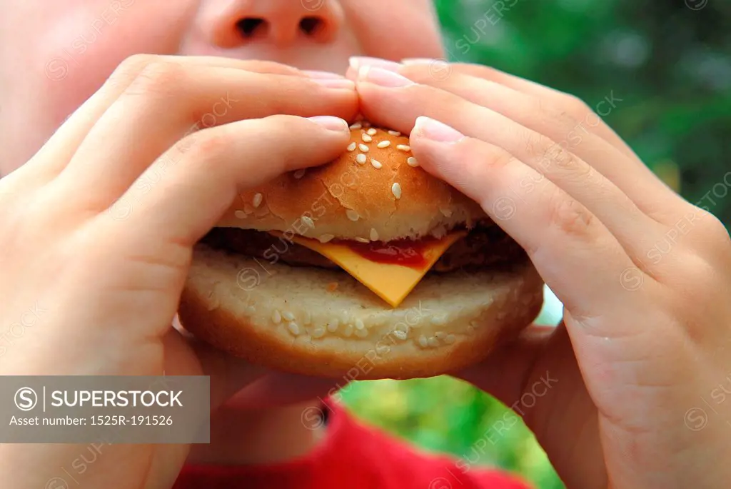 Child eating cheeseburger
