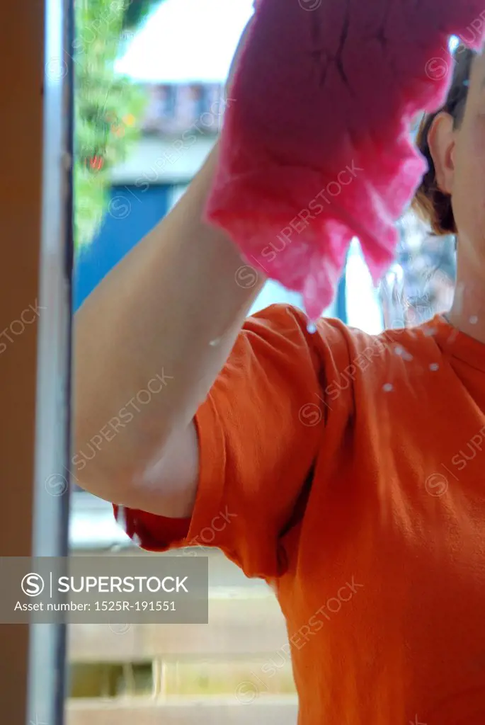 Woman wiping clean windows