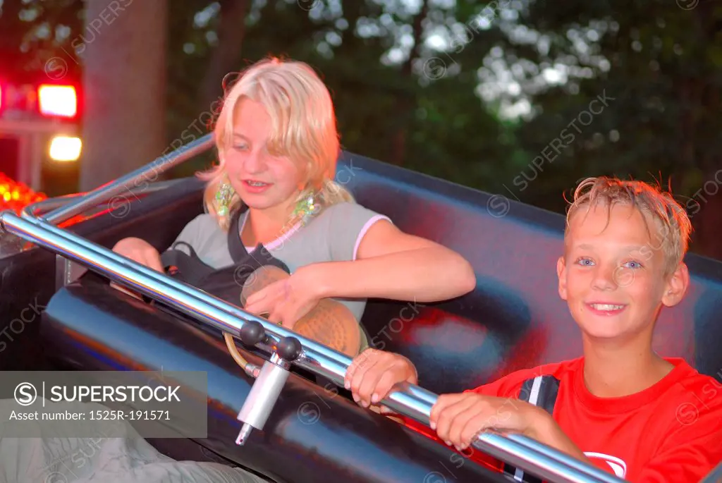 Girl and boy on fairground ride