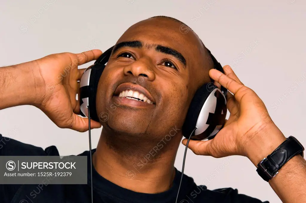 African-American man listening to music on head phones.