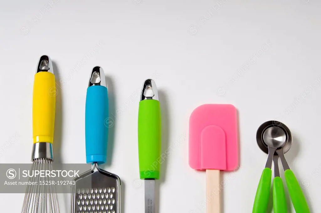 Kitchen utensils with neon accents on a white background.