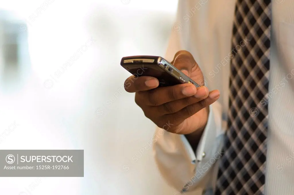 Executive using Blackberry PDA smart phone.