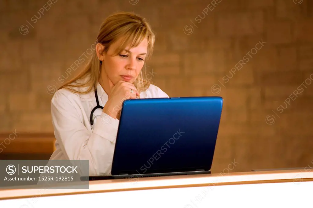 Female doctor with laptop in hospital.