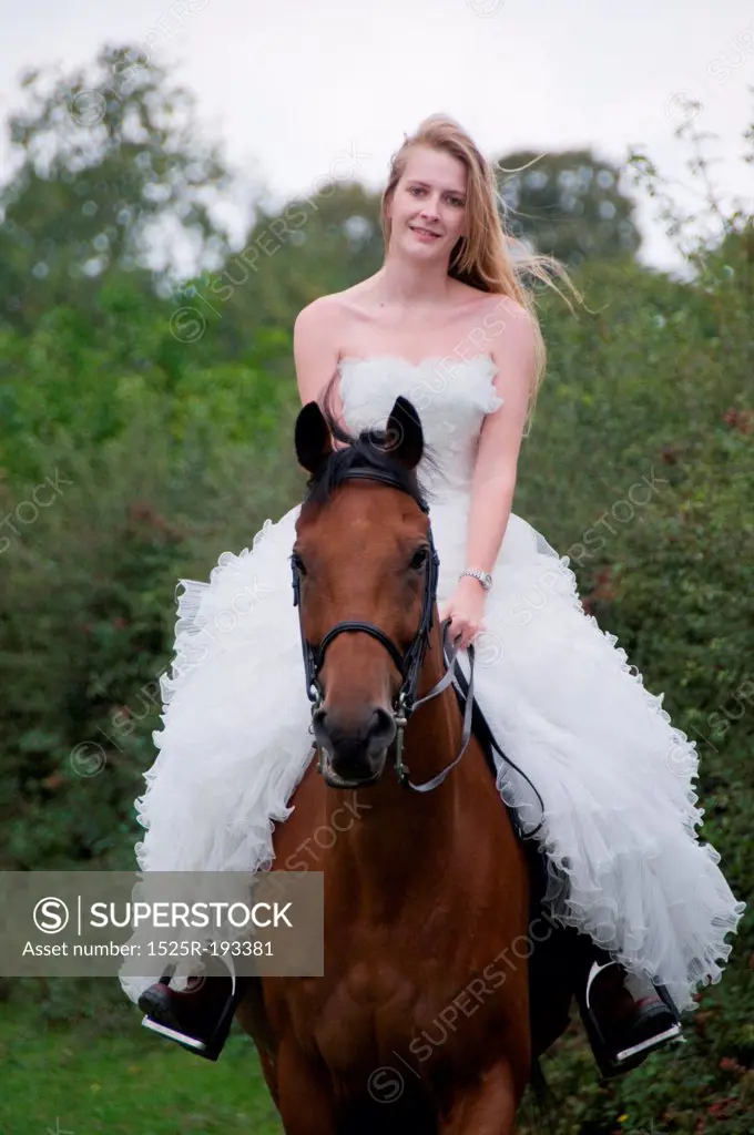 Woman in a wedding dress on a horse