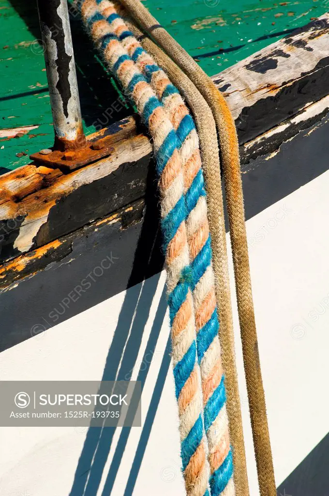 Ropes tied to peir from fishing boat.