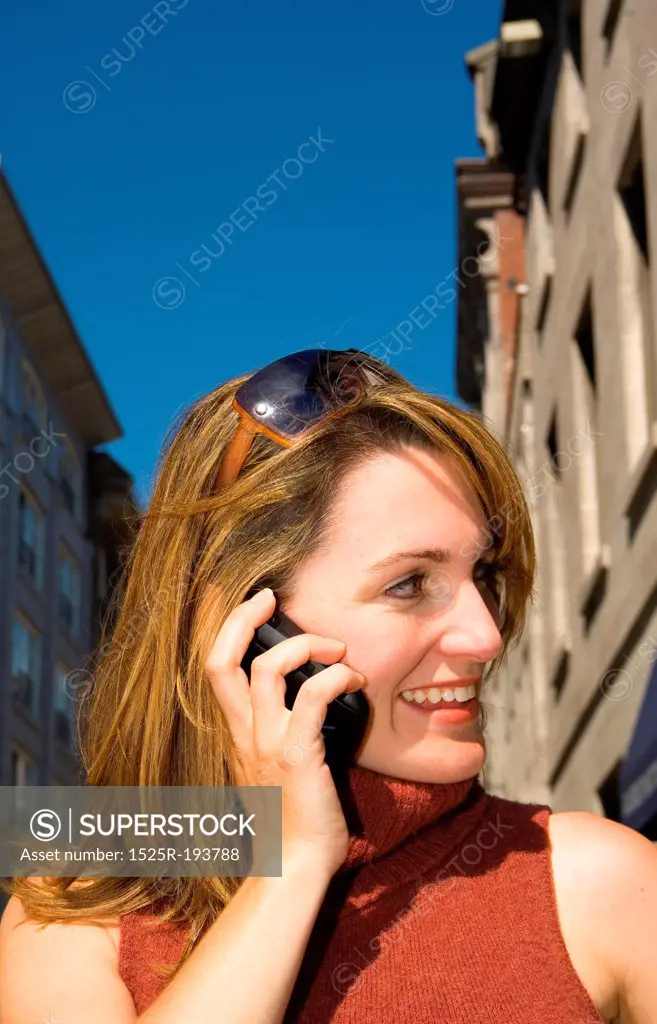 Woman talking on PDA, cellular.